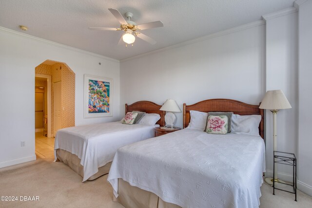 bedroom with light carpet, ceiling fan, and crown molding