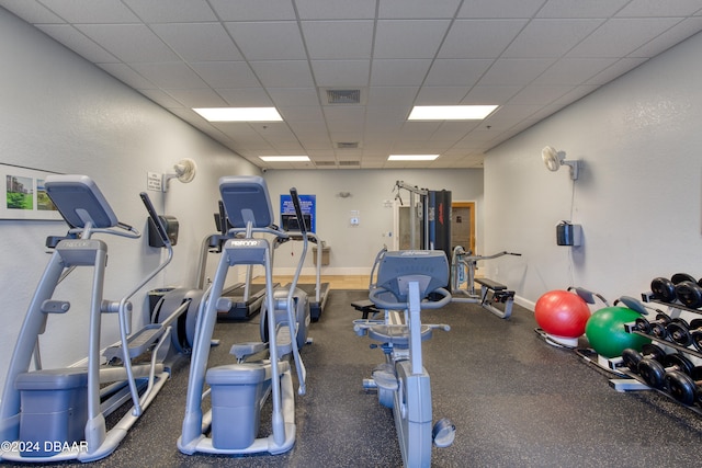 exercise room with a paneled ceiling