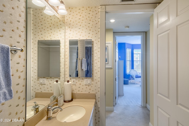 bathroom with vanity and a textured ceiling