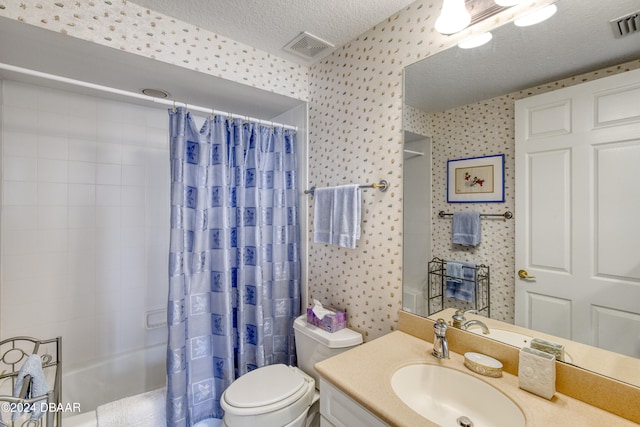 full bathroom featuring vanity, toilet, a textured ceiling, and shower / tub combo with curtain