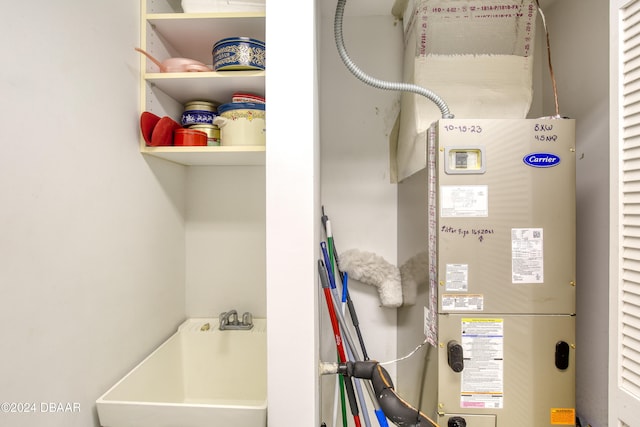 utility room featuring heating unit and sink