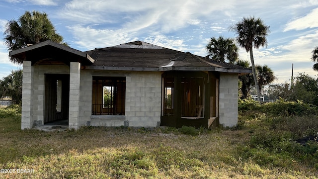 view of side of home with a lawn