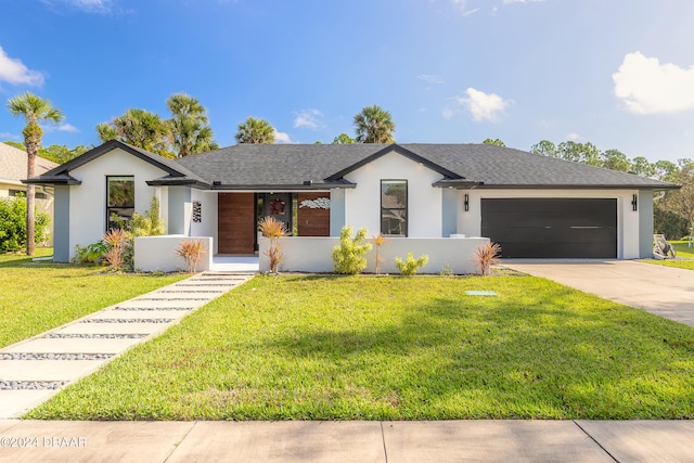 view of front of home with a front yard and a garage