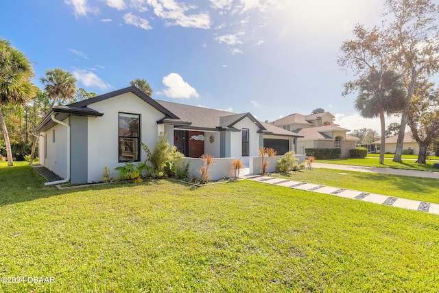 view of front of home featuring a front yard and a garage