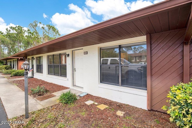 view of exterior entry featuring stucco siding