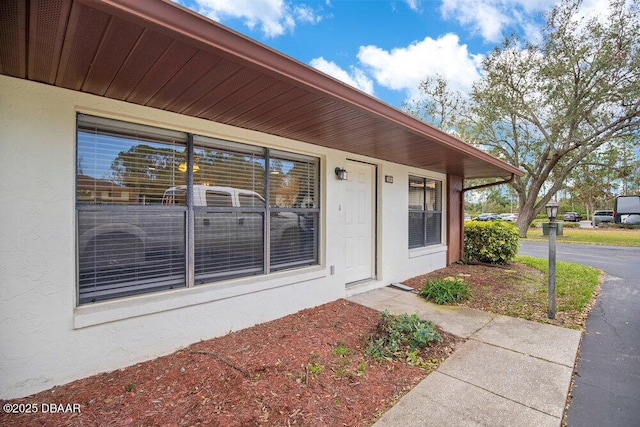 entrance to property with stucco siding