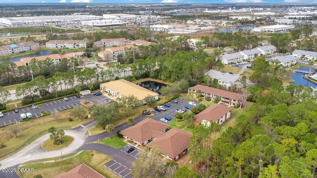 drone / aerial view with a water view and a residential view