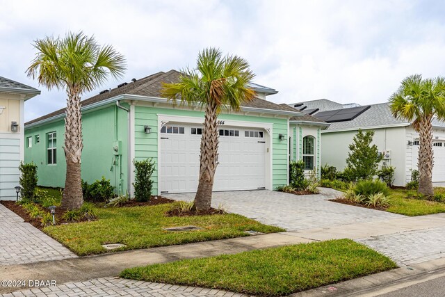 544 Good Life Way, Daytona Beach, FL 32124 - ranch-style home featuring an attached garage and decorative driveway