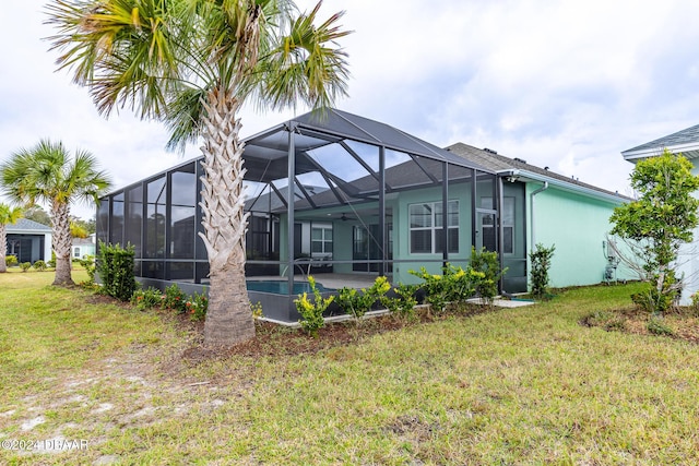 544 Good Life Way, Daytona Beach, FL 32124 - back of house featuring a lawn, a lanai, stucco siding, an outdoor pool, and a patio