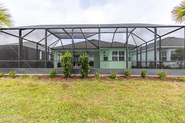 544 Good Life Way, Daytona Beach, FL 32124 - back of house featuring ceiling fan, a lawn, and glass enclosure