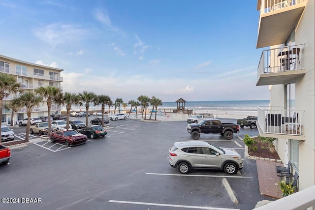 view of parking / parking lot with a water view