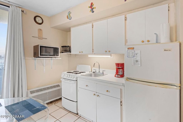 kitchen with white cabinetry, sink, white appliances, and light tile patterned floors