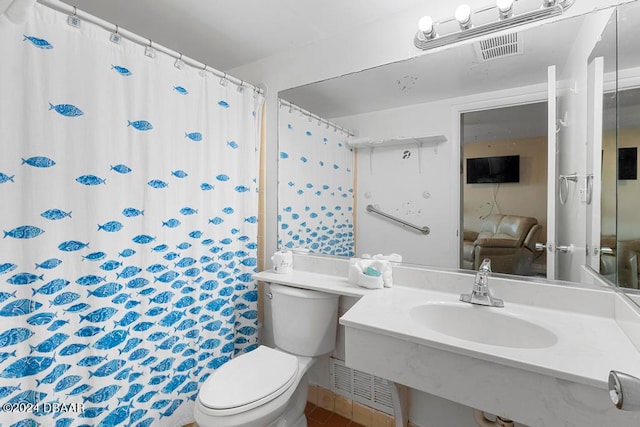 bathroom featuring sink and toilet