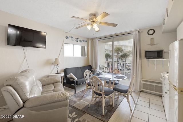 1233 S Atlantic Ave Unit 2270, Daytona Beach, FL 32118 - dining area featuring ceiling fan, light tile patterned flooring, and a wall unit AC