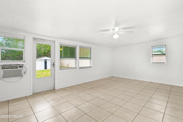 tiled empty room with ceiling fan and a wall unit AC