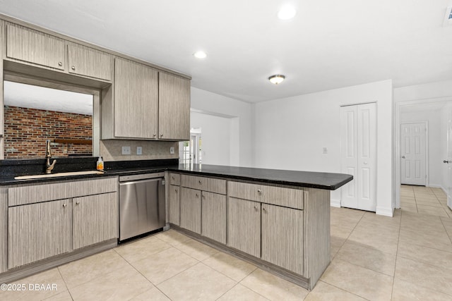 kitchen featuring light tile patterned floors, decorative backsplash, stainless steel dishwasher, sink, and kitchen peninsula