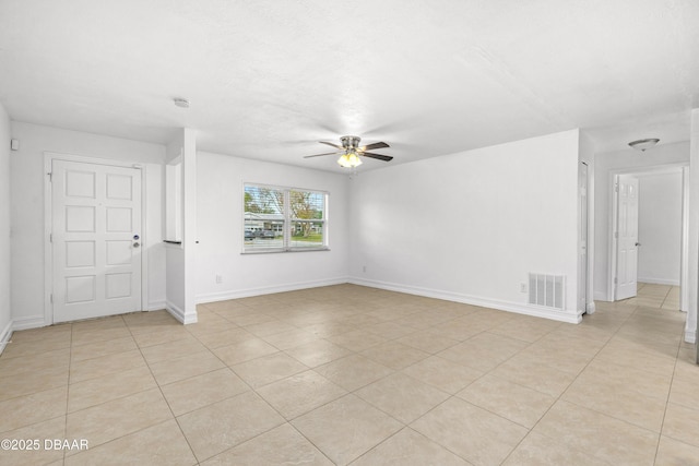 empty room featuring ceiling fan and light tile patterned floors