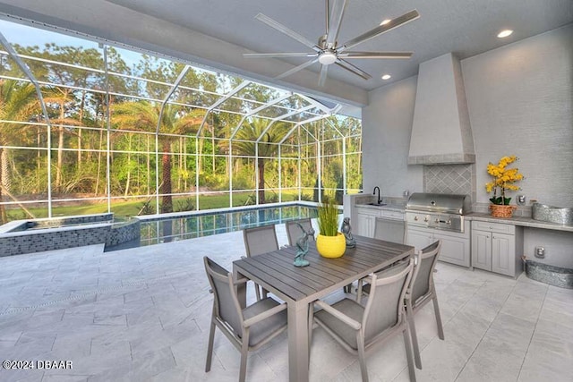 view of patio with sink, glass enclosure, an outdoor kitchen, grilling area, and an in ground hot tub