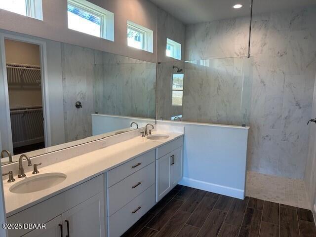 bathroom with walk in shower and vanity