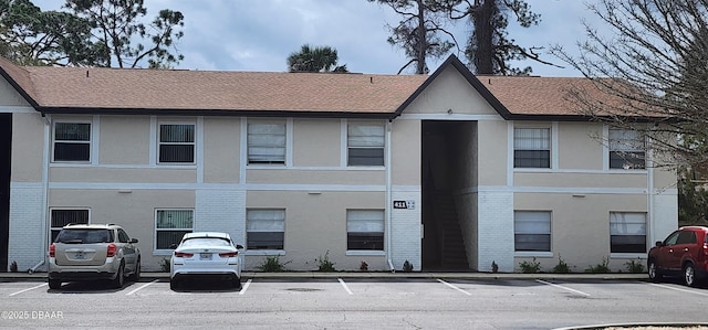 view of building exterior featuring uncovered parking