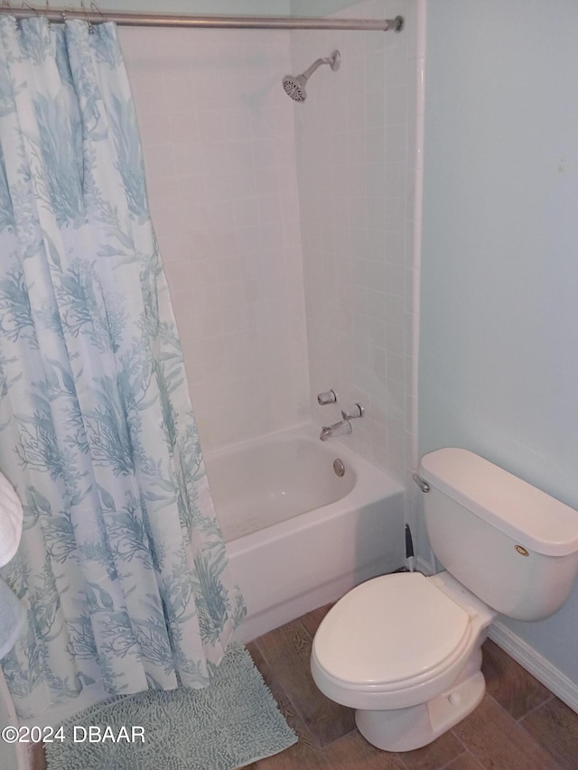 bathroom featuring hardwood / wood-style floors, shower / bath combination with curtain, and toilet