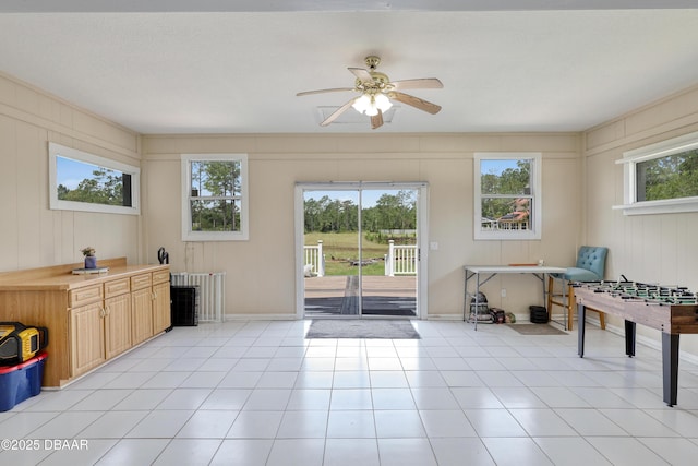 457 Juniper Ln, Ormond Beach, FL 32174 - doorway to outside featuring a ceiling fan, light tile patterned floors, and baseboards