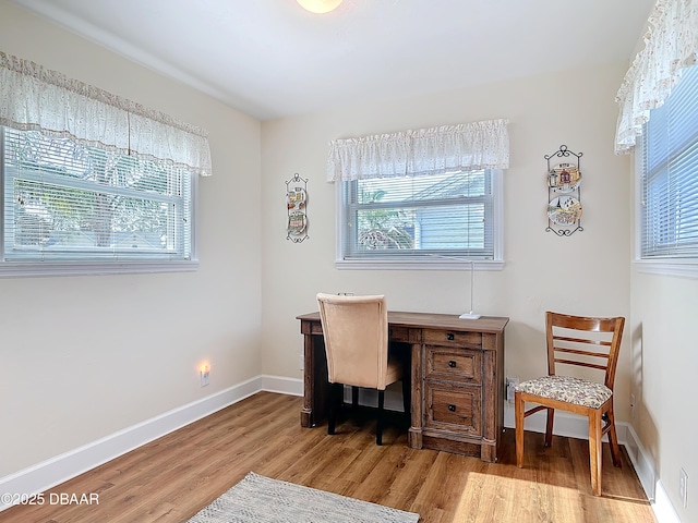 office space featuring baseboards and wood finished floors