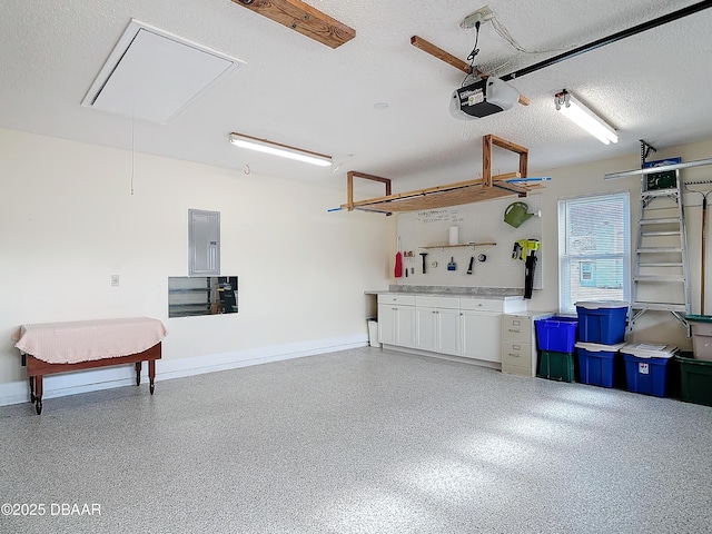 garage featuring electric panel, baseboards, and a garage door opener