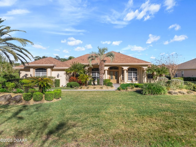 mediterranean / spanish-style house with a front yard