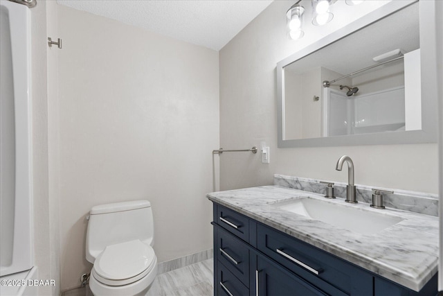 full bathroom featuring toilet, a textured ceiling, vanity, baseboards, and walk in shower