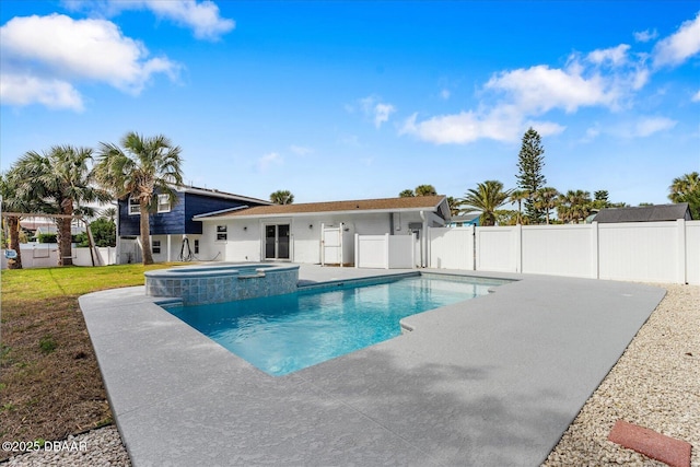 view of pool featuring a pool with connected hot tub, a fenced backyard, and a patio