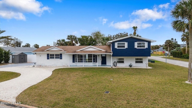 40 Juniper Dr, Ormond Beach, FL 32176 - split level home with driveway, a front lawn, covered porch, and brick siding
