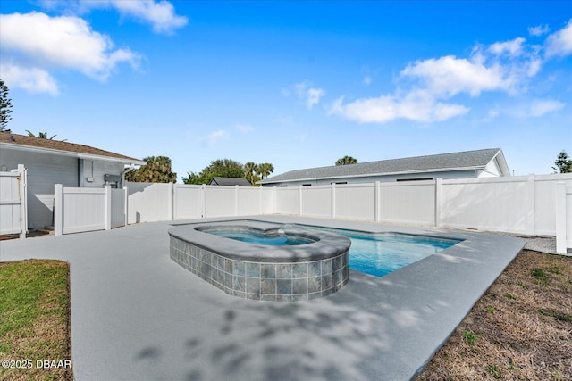 view of swimming pool featuring a patio area, a fenced backyard, and a pool with connected hot tub