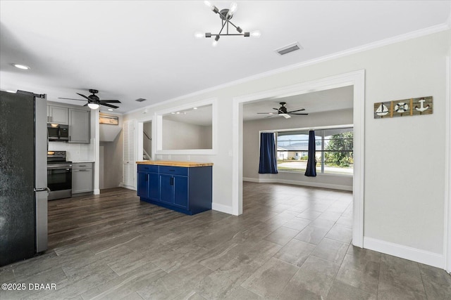 kitchen featuring visible vents, stainless steel appliances, crown molding, and open floor plan