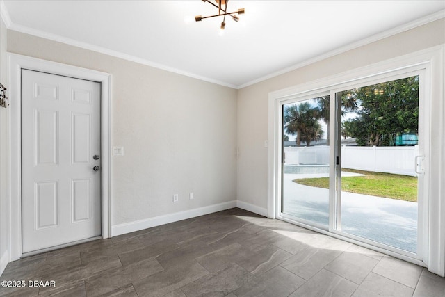 interior space featuring a notable chandelier, baseboards, and crown molding