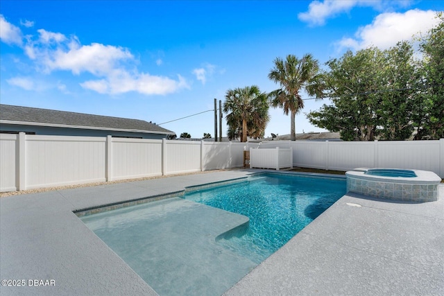 view of pool featuring a pool with connected hot tub and a fenced backyard