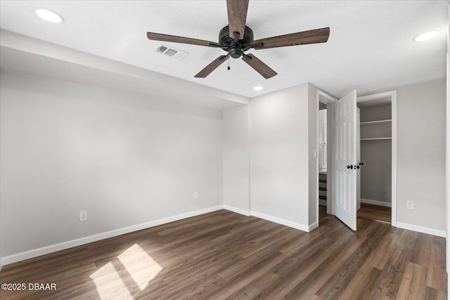 unfurnished bedroom featuring dark wood-style floors, recessed lighting, visible vents, and baseboards