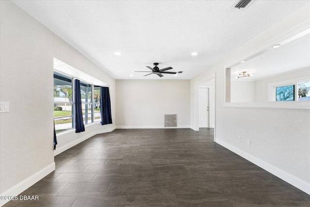 empty room featuring recessed lighting, visible vents, ceiling fan, a textured ceiling, and baseboards