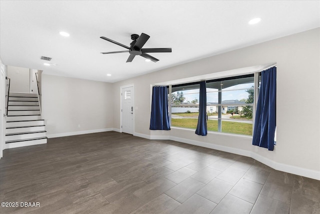 unfurnished living room with baseboards, stairs, and visible vents