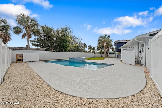 view of swimming pool featuring a patio area, a fenced backyard, and a pool with connected hot tub