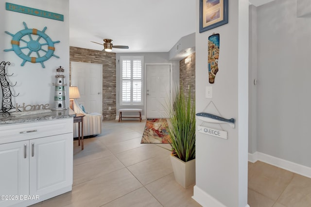 interior space with light tile patterned floors and baseboards