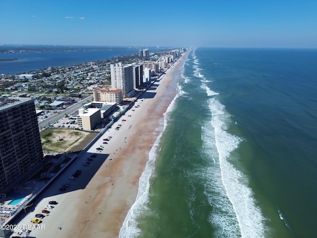 aerial view featuring a view of city, a beach view, and a water view