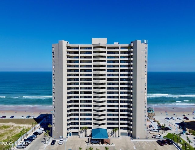 view of property featuring a water view and a view of the beach