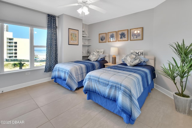 bedroom with a ceiling fan and baseboards