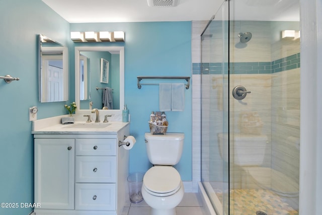 bathroom with tile patterned floors, vanity, toilet, and a shower stall