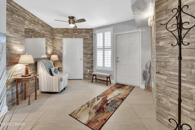 interior space with tile patterned floors and a ceiling fan