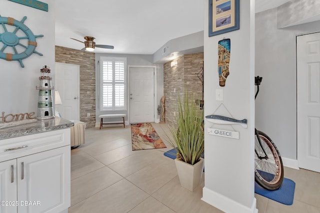 full bath with tile patterned floors, visible vents, a ceiling fan, a tile shower, and vanity