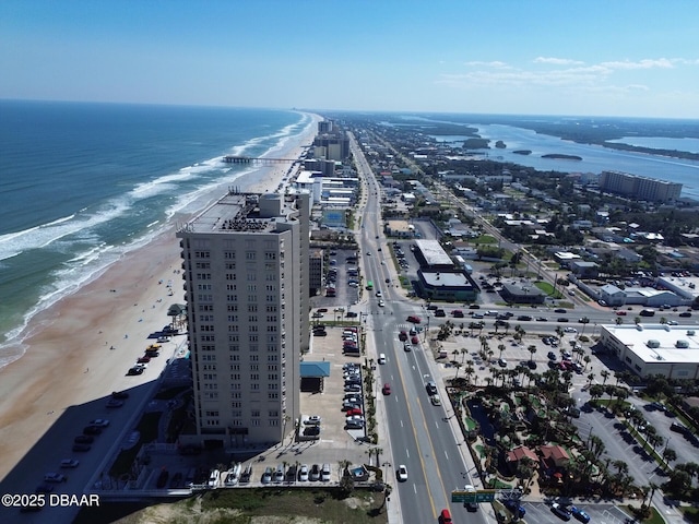 birds eye view of property featuring a city view, a view of the beach, and a water view