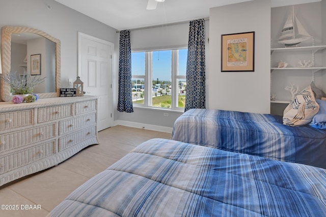 bedroom featuring light tile patterned floors and baseboards