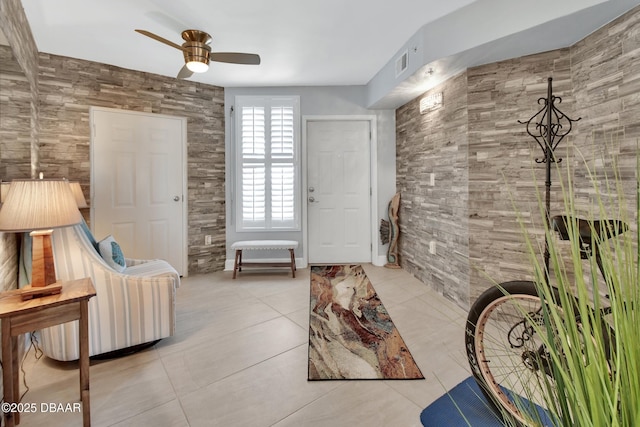 foyer entrance with tile patterned floors, visible vents, and a ceiling fan